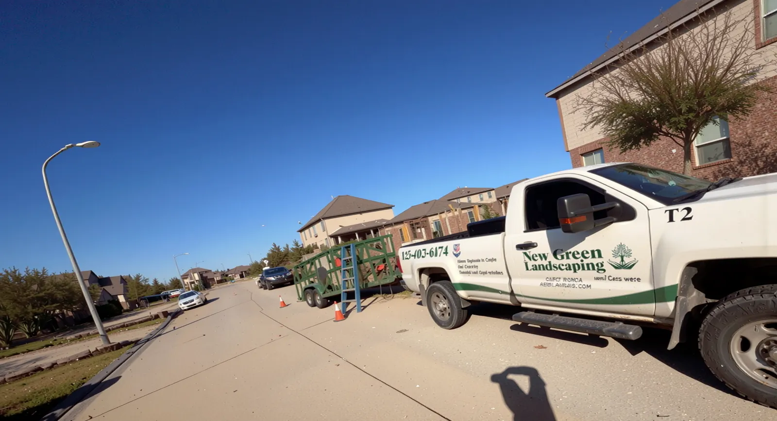 New Green Landscaping work truck parked at a job site in Houston, TX